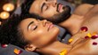 © EmmaStock - A couple enjoying a romantic side-by-side massage in a luxury spa, lying on adjacent massage tables with flower petals and aromatherapy oils surrounding them