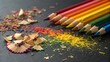 © Luckystation - Rainbow of Creativity: A vibrant row of sharpened colored pencils rest on a dark surface, their colorful shavings scattered around like confetti, symbolizing the boundless potential of creativity.