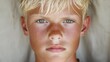 © danadesa - Blond boy portrait, serious expression, outdoor background, for website or magazine
