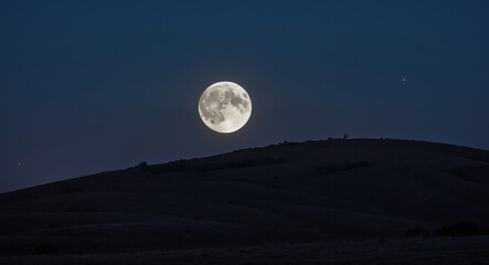 Poster - Majestic Full Moon Illuminating Night Sky Above Rolling Hills With Copy Space For Text