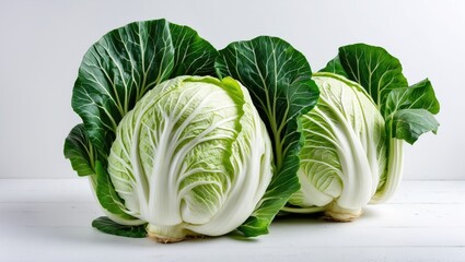 Wall Mural - Fresh and vibrant napa cabbage with crisp leaves arranged elegantly on a clean white background for healthy food concepts and recipes.