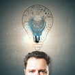 © Who is Danny - Businessman's head with glowing lightbulb and sketch of business ideas.