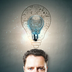 Canvas Print - Businessman's head with glowing lightbulb and sketch of business ideas.