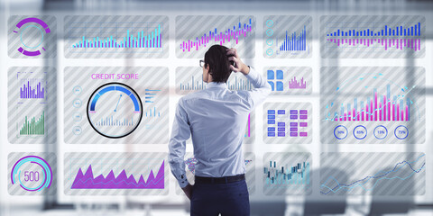 Wall Mural - Businessman analyzing digital financial charts on virtual screen.