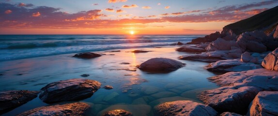 Aufkleber - Coastal sunset landscape with rocky shoreline and gentle waves reflecting colors in water, golden hour scenery, Copy Space
