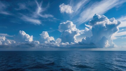 Wall Mural - dramatic cloud formations above calm ocean waters with bright blue sky and gentle waves copy space
