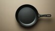 © Iurii - Hard-anodized frying pan with gray finish and silicone grip on neutral background