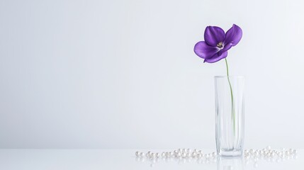 Poster - Elegant Purple Flower in Sleek Glass Vase Against Minimalist Background with Decorative Pearls