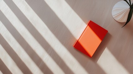 Poster - Sleek Modern Lamp Casting Sharp Shadows on Elegant Surface with Decorative Book and Plant Arrangement
