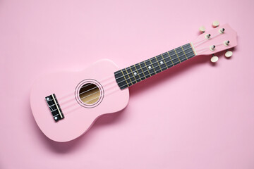 Wall Mural - One ukulele on pink background, top view