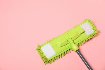 Wall Mural - Microfiber mop on pink background, above view. Space for text