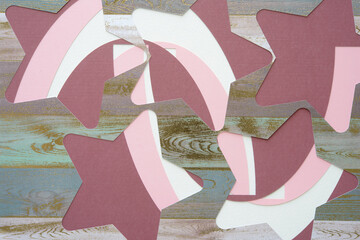 Wall Mural - paper stencil with star shape cutouts on purple and pink machine-cut paper forms on white