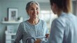 © Pat J. - A happy elderly woman using a walker, helped by a medical professional in a spacious and welcoming therapy environment