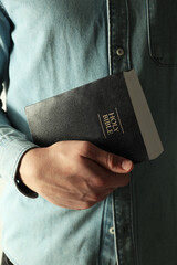 Wall Mural - Man with hardcover Holy Bible, closeup view