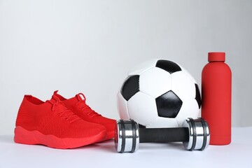 Wall Mural - Sports equipment, sneakers and water bottle on white background