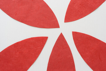 Wall Mural - red paper shapes arranged in radial form on blank paper