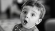 © AlfaSmart - Surprised child with open mouth expression in black and white