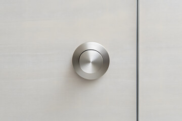 Poster - Modern minimalist door with a round metal flush pull detail, offering a sleek and understated design. The door's subtle texture adds a touch of sophistication.