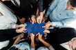 © InfiniteFlow - Top view multiethnic business people holding jigsaw pieces and merge them together as effective solution solving teamwork, shared vision and common goal combining diverse talent. Meticulous