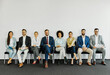 © Lumos sp - man business chair sitting waiting businessman candidate recruitment office businesswoman woman businessperson job young interview line employee career row hall colleague