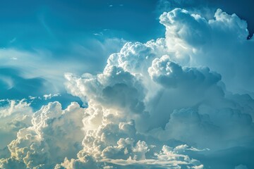 Poster - Cloud formations display a vibrant array of blues and whites, illustrating the beauty of a dramatic sky at midday