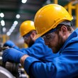 © Mandeep - Factory Workers in Blue Overalls
