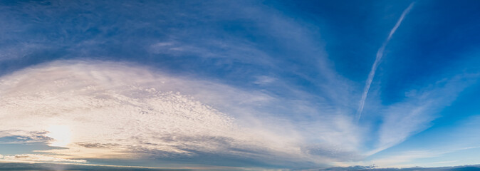 Wall Mural - Expansive Sky with Contrasting Clouds and Blue Horizon at Sunset