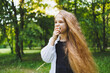 © DSMT - A young girl enjoys the outdoors, surrounded by nature, with her hair dancing in the breeze