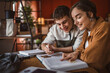© Miljan Živković - man student help his woman colleague to prepare exam and support her