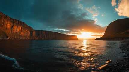 Wall Mural - Dramatic sunset over a serene coastal landscape with towering cliffs and calm ocean waters.