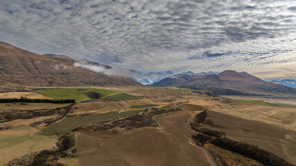 Wall Mural - Drone  view of the Ashburton highlands with a river an lake in the dry arid terrain on the way to Lake Heron