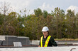 © Ron - Male civil engineer in safety suit is checking the quality of slabs and precast floorboards in a factory. Construction worker uses a check list to inspect the precast products.