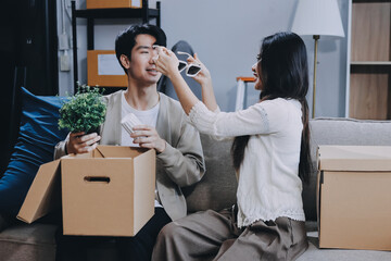 Wall Mural - Smiling couple unpacking boxes in new house