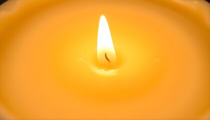 Wall Mural - a yellow lit candle with a black background