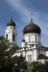 Wall Mural - building, domes and crosses of the Orthodox Cathedral of Archangel Michael in the city of Lomonosov (Oranienbaum) in the summer against the blue sky