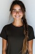 © marimalina - Young woman with long braided hair smiling confidently in a neutral background during a casual indoor setting