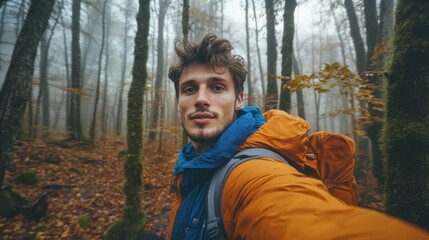 Aufkleber - Young man captures hiking adventure in misty forest during autumn exploration