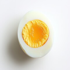 Poster - Boiled egg cut in half showing bright yellow yolk on a clean white background