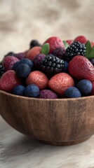 Poster - Rustic wooden bowl filled with an assortment of fresh berries in a natural setting