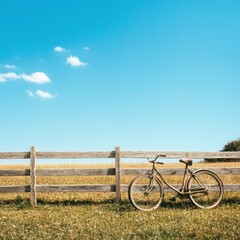 Poster - Bicycle resting against wooden fence under clear blue sky in open field during sunny day. Generative AI