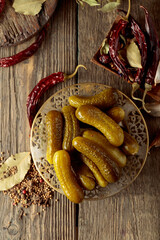 Canvas Print - Pickled cucumbers with ingredients on an old wooden table.