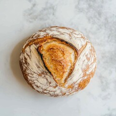 Aufkleber - Freshly baked rustic sourdough bread on a light surface with a golden crust and beautiful scoring