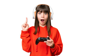 Wall Mural - Little caucasian girl playing with a video game controller over isolated background thinking an idea pointing the finger up