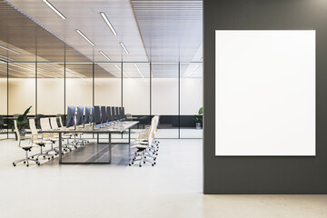 Wall Mural - Modern office interior with empty white mockup board on dark wall. Glass-walled conference room with desks and computers in background. 3D Rendering