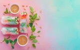 Fresh summer rolls with peanut dipping sauce on a pastel background