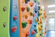 © Fotograf - Colorful climbing wall in a school gym setting