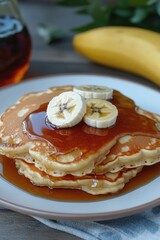 Poster - A delicious breakfast or brunch scene with pancakes, syrup, and sliced bananas