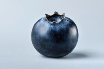 Poster - A single blueberry on a white surface, great for food or product photography