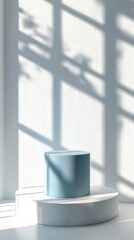 Poster - A pastel blue cylinder podium stands on a white platform, bathed in soft, afternoon light. Delicate shadows from nearby foliage dance across the textured walls, creating a serene atmosphere