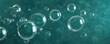 © Sutasinee - Teal background with bubbles floating in mid-air, aerated, lighthearted, teal